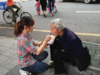 深圳90後女孩當街給殘疾乞丐餵飯 感動路人